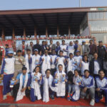 Athletes pose for a group photograph.