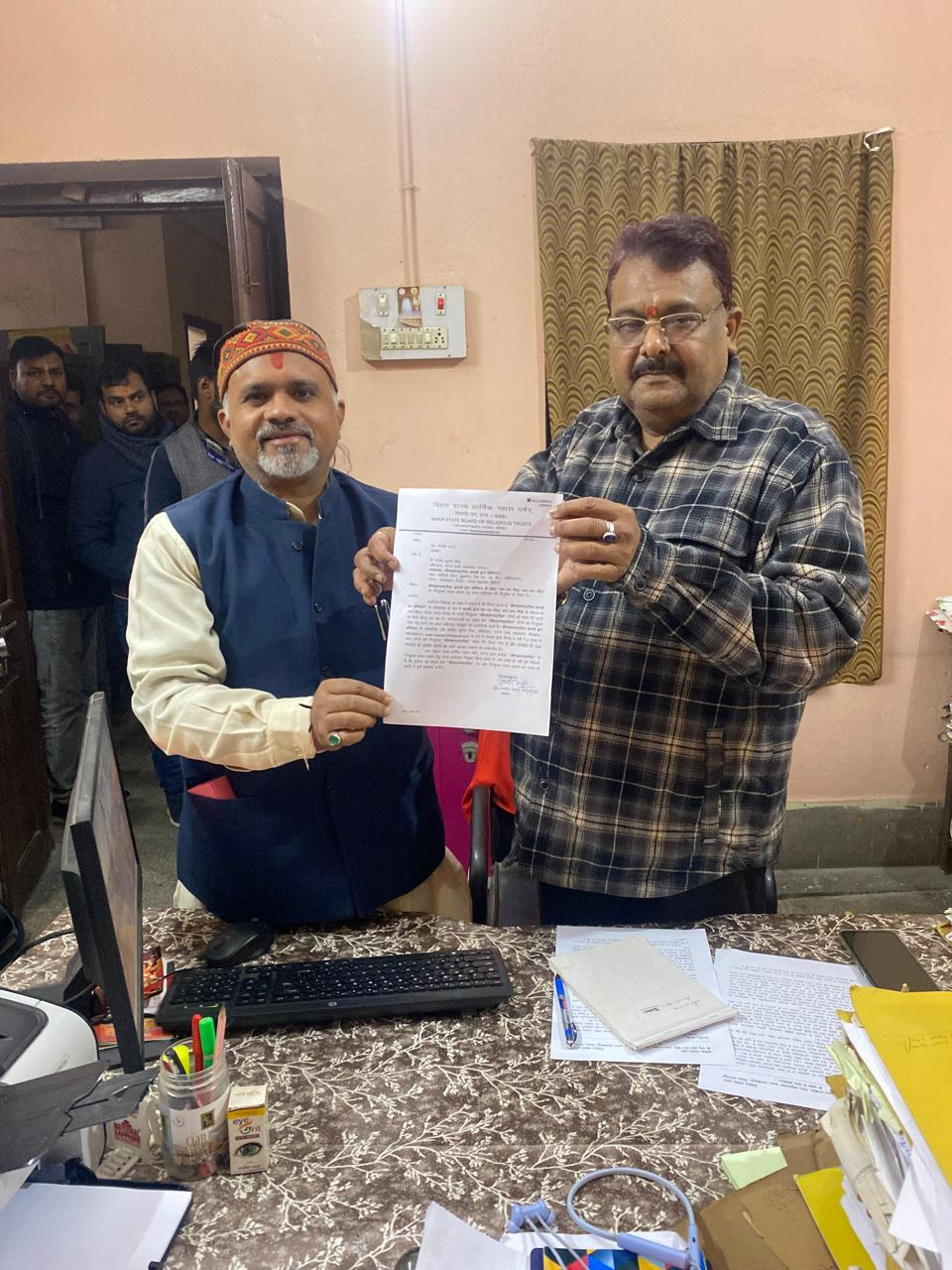 Advocate Sanjeev Kumar Mishra receiving letter from Bihar Religious Trust Board Chairman Professor Ranbir Nandan