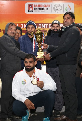 Chandigarh University wrestling medalists along with University officials receiving the overall champions trophy in AIU Wrestling Championship held at Chandigarh University