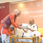 Subodh Tiwari presenting the Kaivalyadhama coffee table book to Gurudev Sri Sri Ravi Shankar