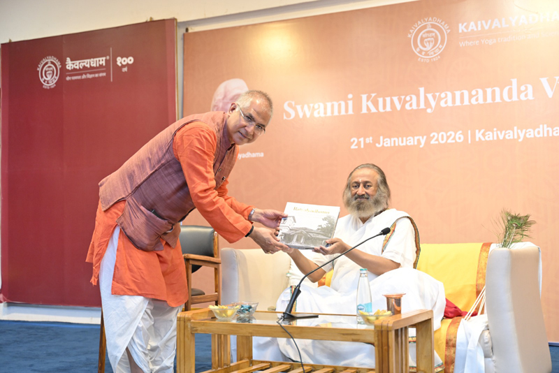 Subodh Tiwari presenting the Kaivalyadhama coffee table book to Gurudev Sri Sri Ravi Shankar
