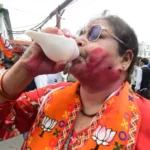 A Bihar BJP worker celebrates party's victory in Assembly elections at state headquarters in Patna.