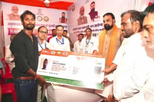 Bihar Chief Minister Samrat Choudhary giving a scheme card to a beneficiary during Block Cooperation and Public Welfare Camp in Patna on June 17, 2026.